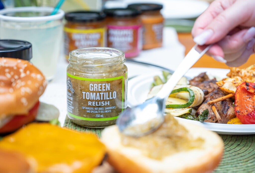 Lineup of Farm Boy Relishes in background with BBQ items in foreground