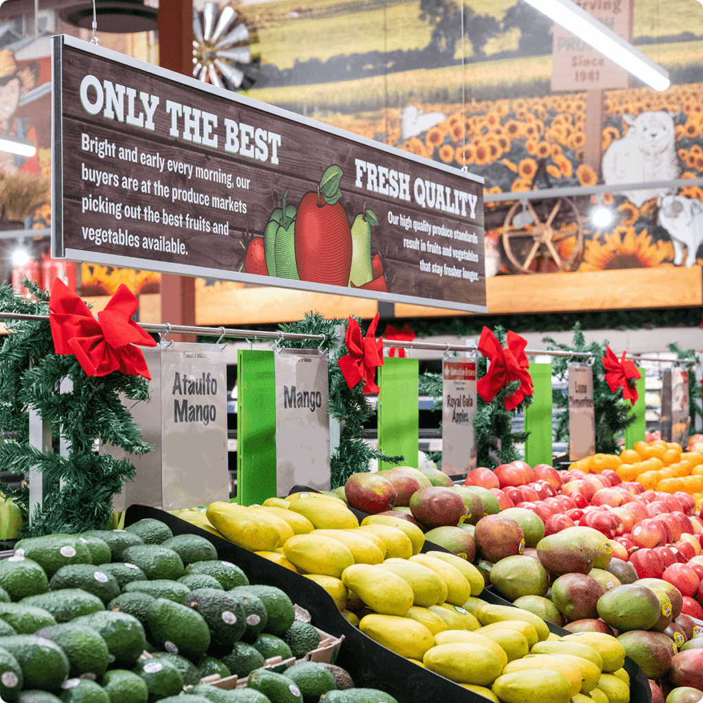 Fresh Avocados, Mangos and Apples displayed in-store.