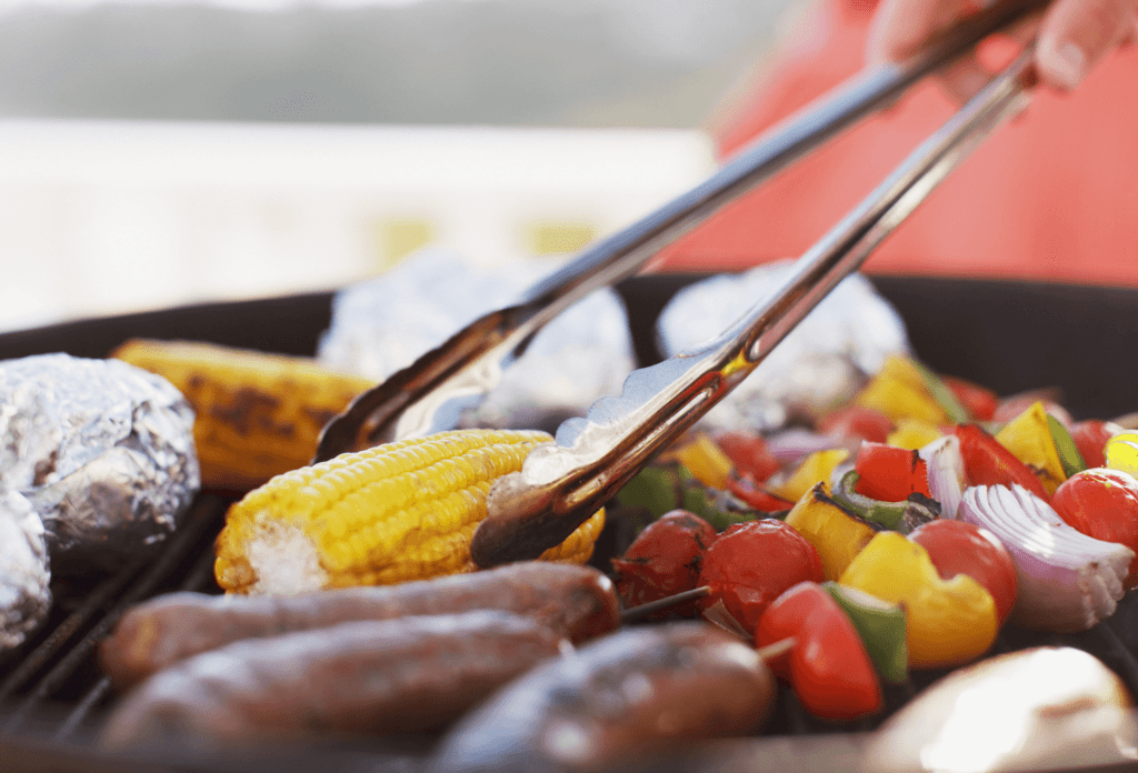 BBQ side shot of grilling vegetables and sausages