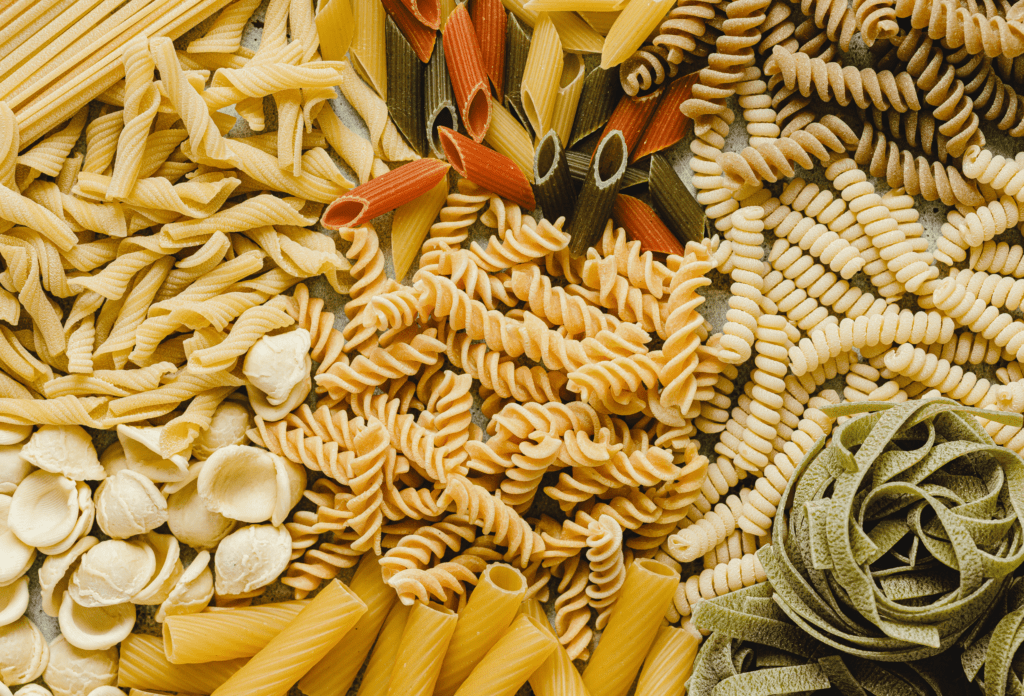 Overhead view of variety of dried pasta shapes.