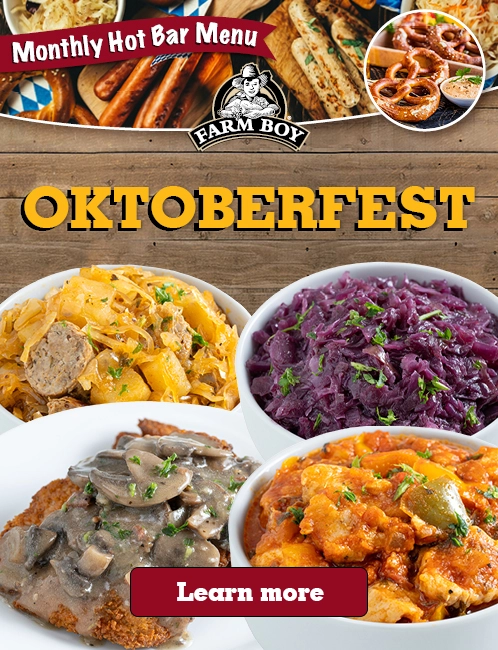 An l image for Oktoberfest at our hot bar. It features a variety of traditional German dishes, including sausages, sauerkraut, red cabbage, schnitzel, and goulash. The image has a festive Oktoberfest theme with a "Learn more" button at the bottom.