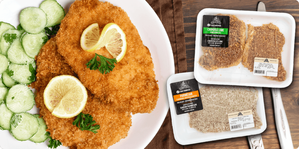 A close-up photo of a pre-packaged Farm Boy Schnitzel on a white plate. The schnitzel is a breaded chicken cutlet. Text on the packaging reads "Pork Chipotle Lime" and "Chicken Parmesan."