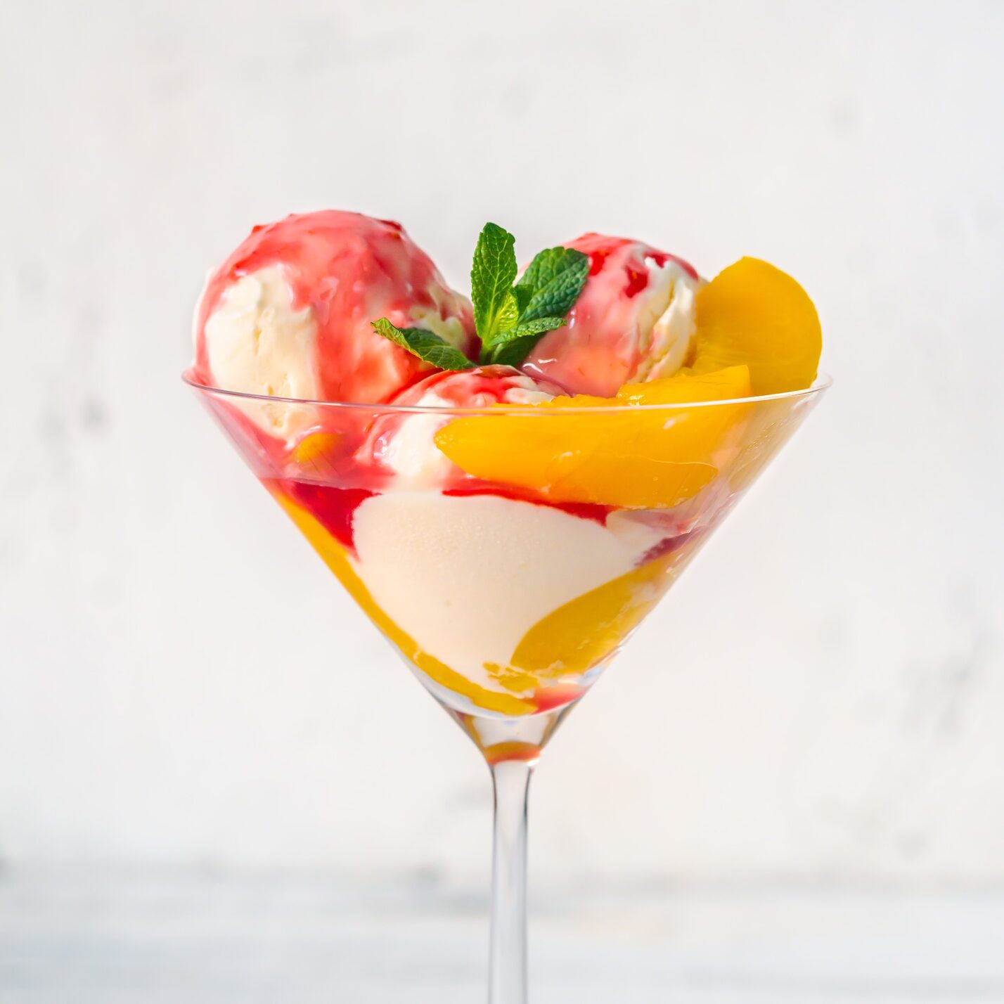 Peach Melba in  cocktail glass. 