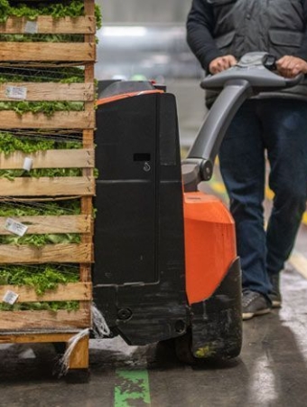 grocery worker using pallet truck