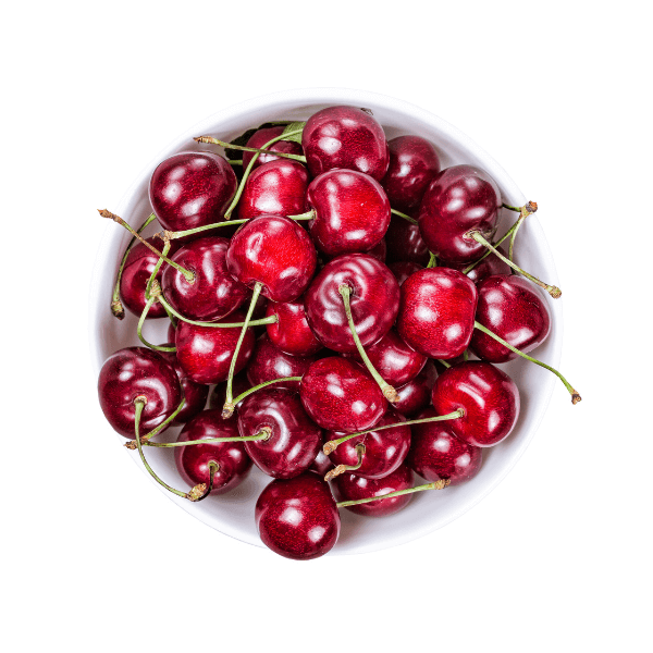 White bowl of red cherries (small stones fruits) on white background.