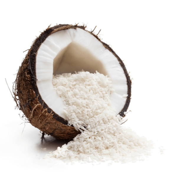 Cut-open coconut half with shredded coconut spilling out on white background.