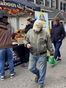 Man walks away from Farm Boy event table with a coupon.