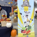 Close up of the Farm Boy event banner alongside pumpkins.