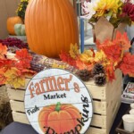 A fall harvest display and a vintage sign saying Farmer's Market.