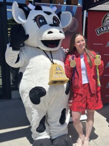 Farm Boy's Lulu stands beside Rosie MacLennan, a four-time Olympian, has she displays her medals during a meet and greet at the Canada Day celebrations.