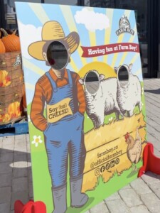 Carnival photo opt with three head holes to place ones face to become one of the Farm Boy mascots.