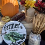 Fall display of a pumpkin and a vintage Farmer's Market sign.