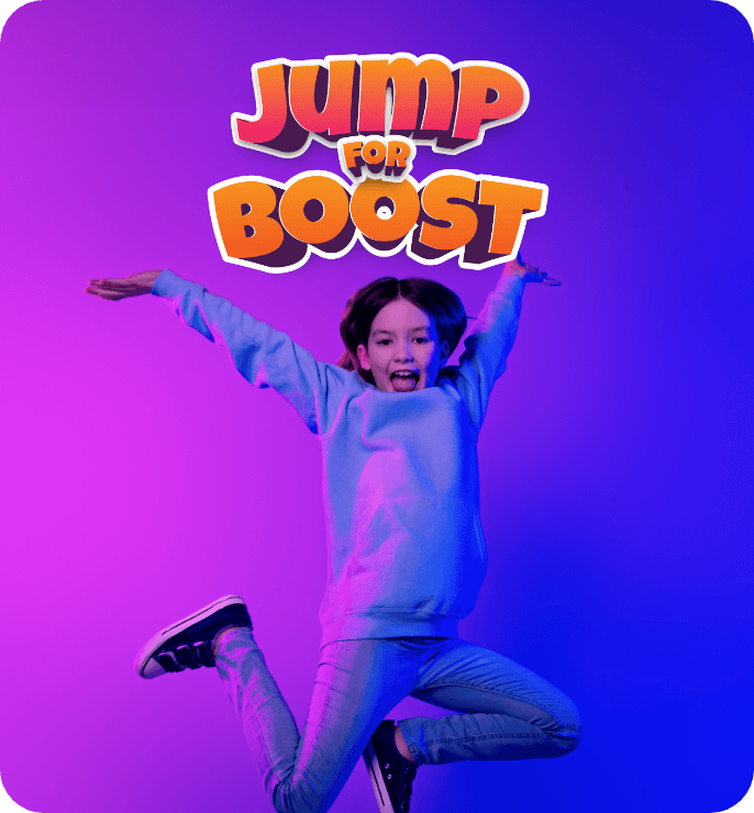 Image of a girl jumping up with her arms in the air.