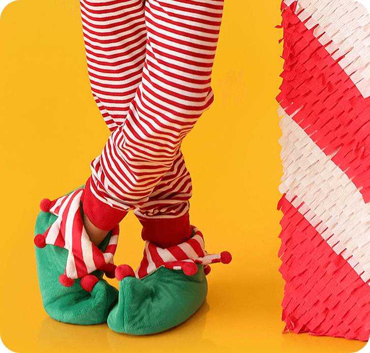 Close up of a pair of Elf legs in stripes pants with fancy shoes.