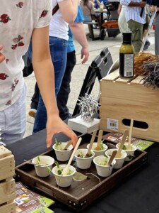 Close up of one customer taking a free Farm Boy sample from the event table.