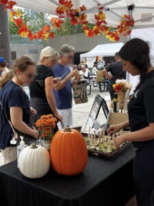 Festival goers walking by the Farm Boy event table.