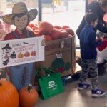 Sign of Farm Hand holding information about the Halloween Hunt for children.