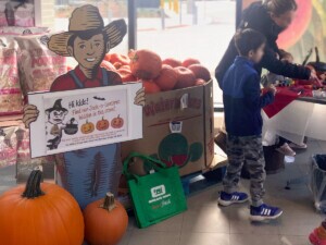 Sign of Farm Hand holding information about the Halloween Hunt for children.