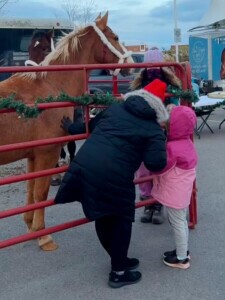 Two people petting a horse. 