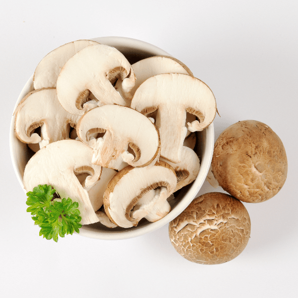 Bowl of sliced cremini mushrooms.