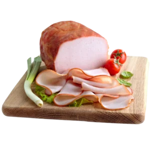 A Whole Deli Turkey Meat sliced into thin slices placed on a board. 