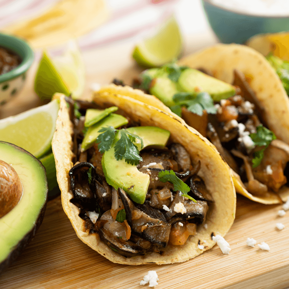 A zoomed in image of wild mushroom tacos on a serving board!