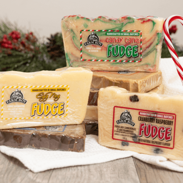 Three varieties of Farm Boy Fudge in holiday flavours with holiday decor for a gift.