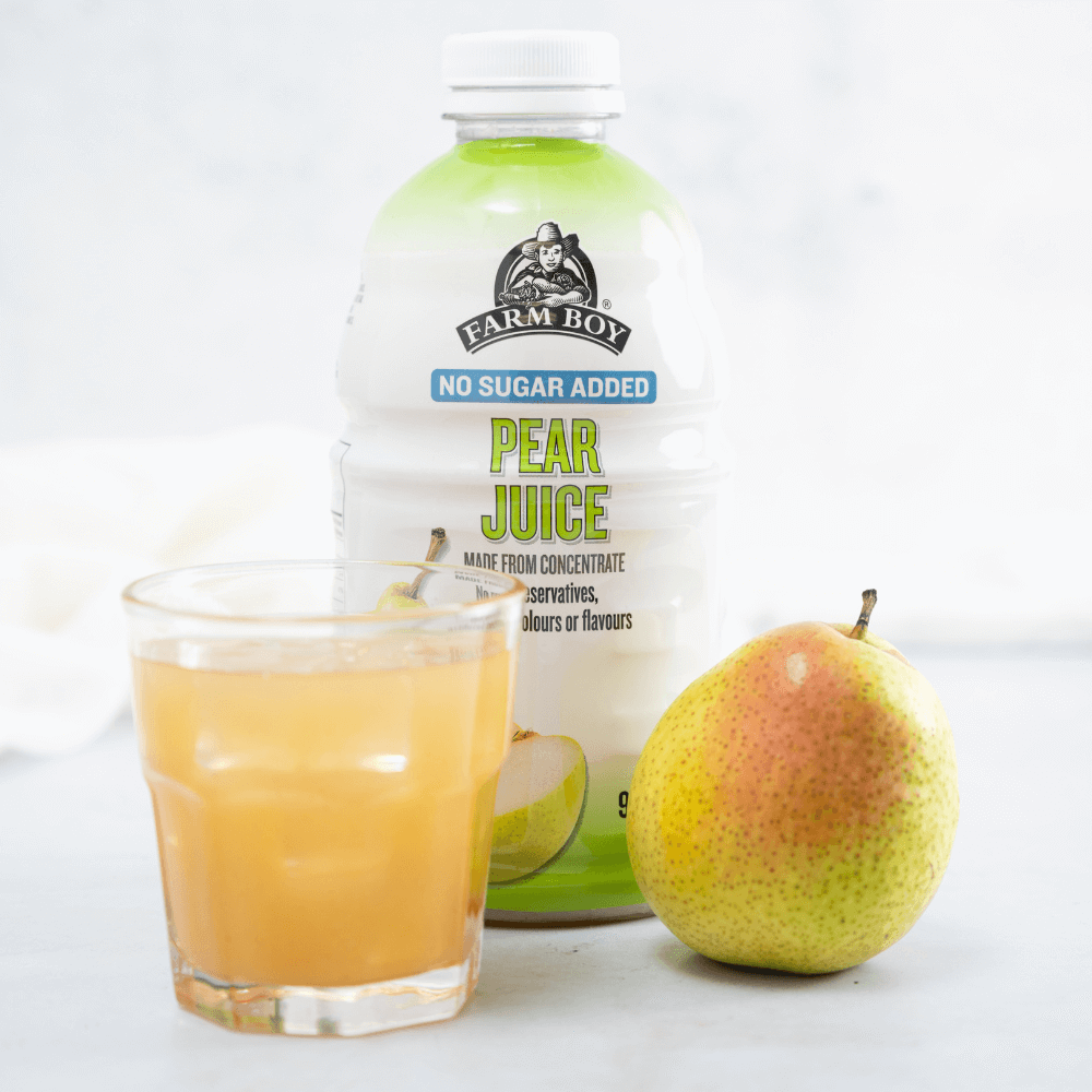 Bottle of Farm Boy™ Pear Juice with filled short glass and whole pear.