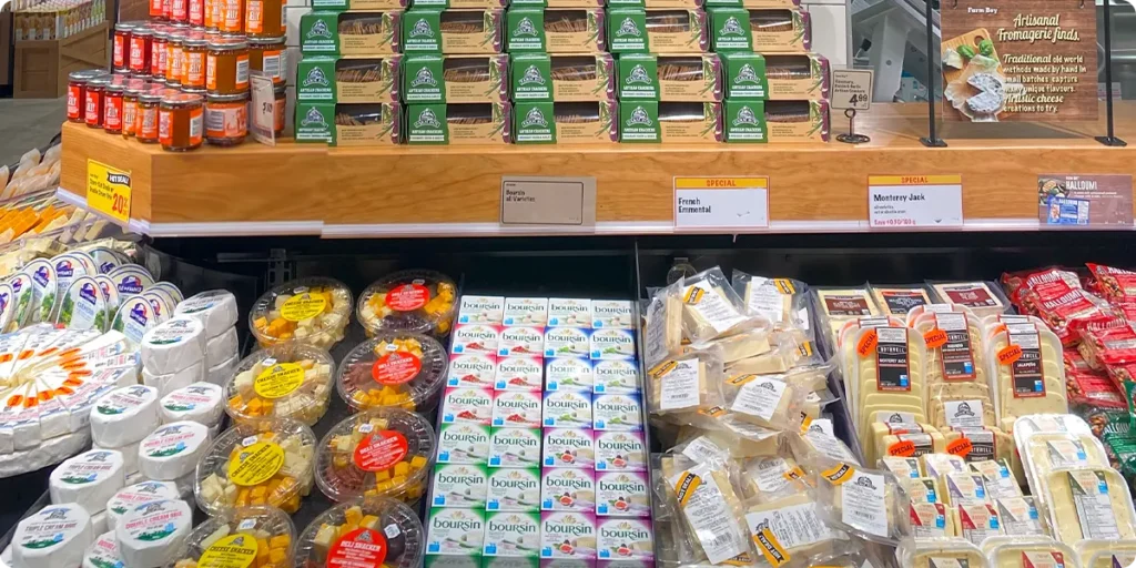 A display of the varieties of cheese available at a Farm Boy grocery store.
